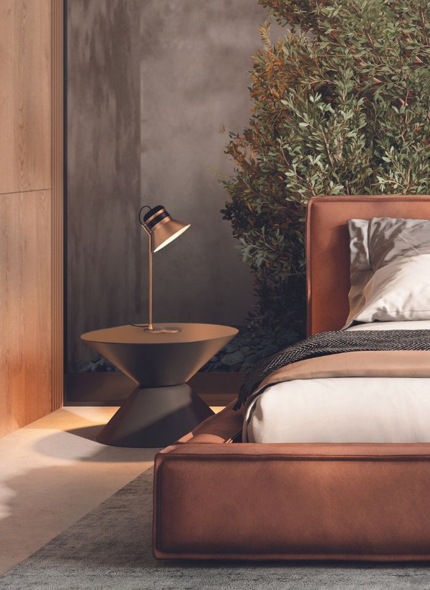 Lampada da tavolo Cordea di Masiero in finitura bronzo satinato, ambientata su comodino