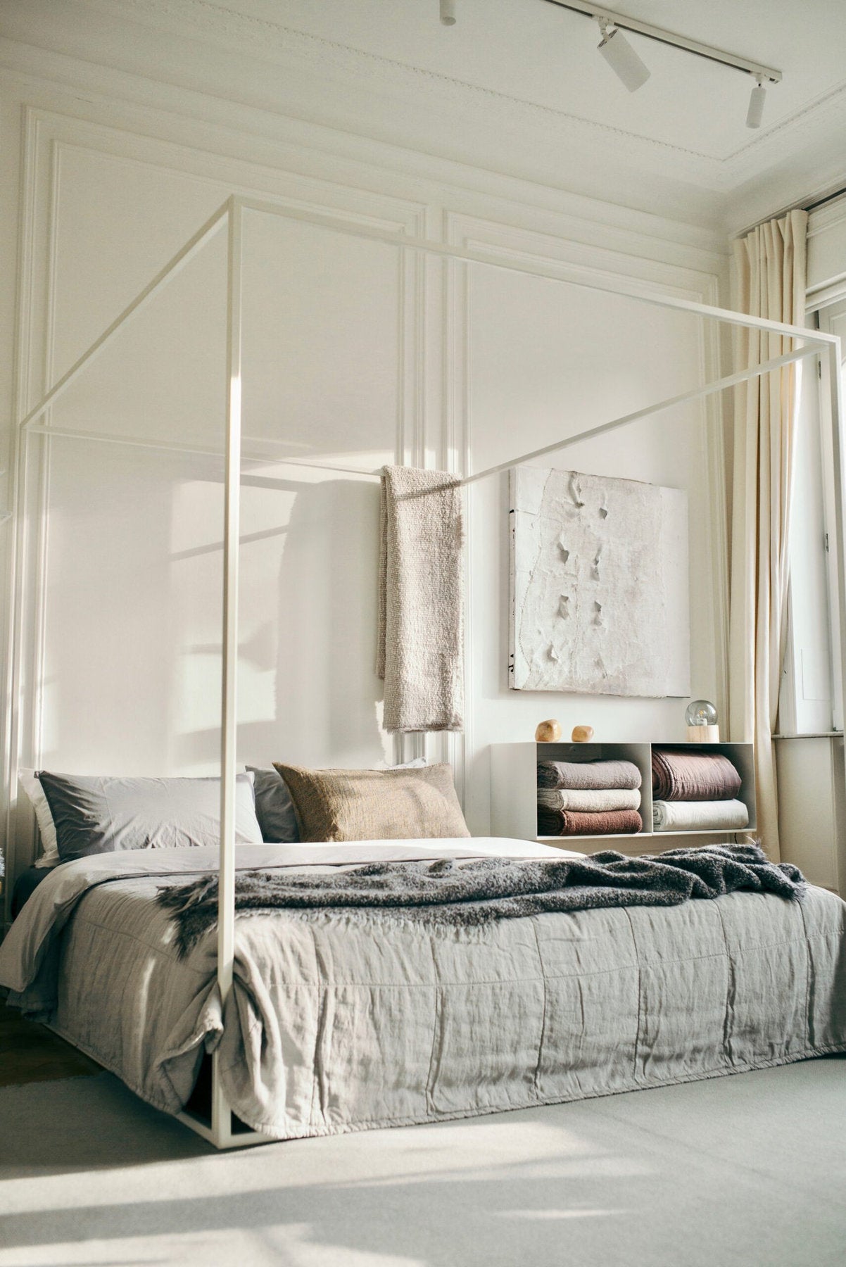 Letto Asha di Xam in metallo bianco in stanza luminosa con cornici a parete