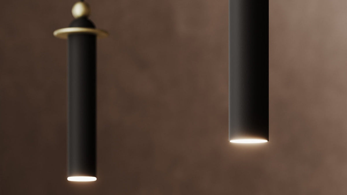 Dettaglio dei corpi luce Serica Dot Masiero in metallo nero con LED integrato e finiture dorate.