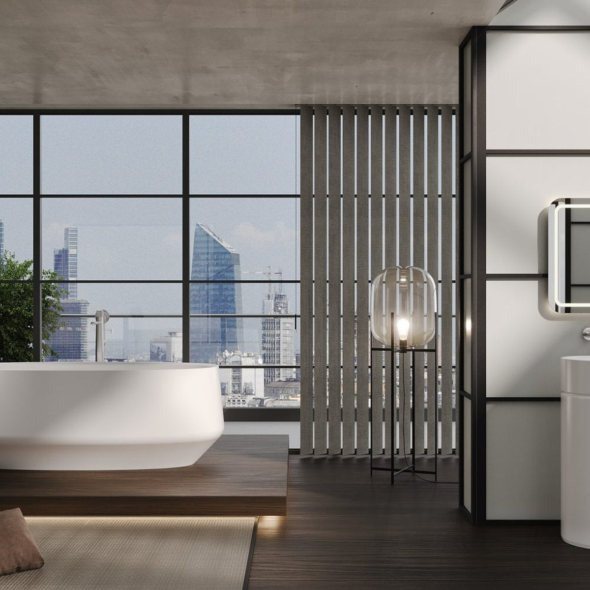 Vasca da bagno ovale IKI freestanding bianco opaco in ambiente contemporaneo con lavabo colonna